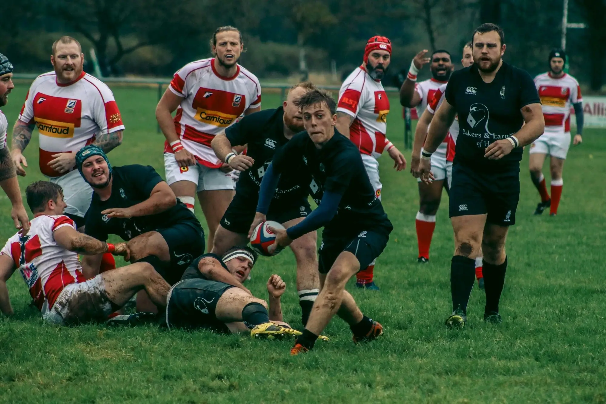 A rugby player passing the ball after recovering it from a ruck
