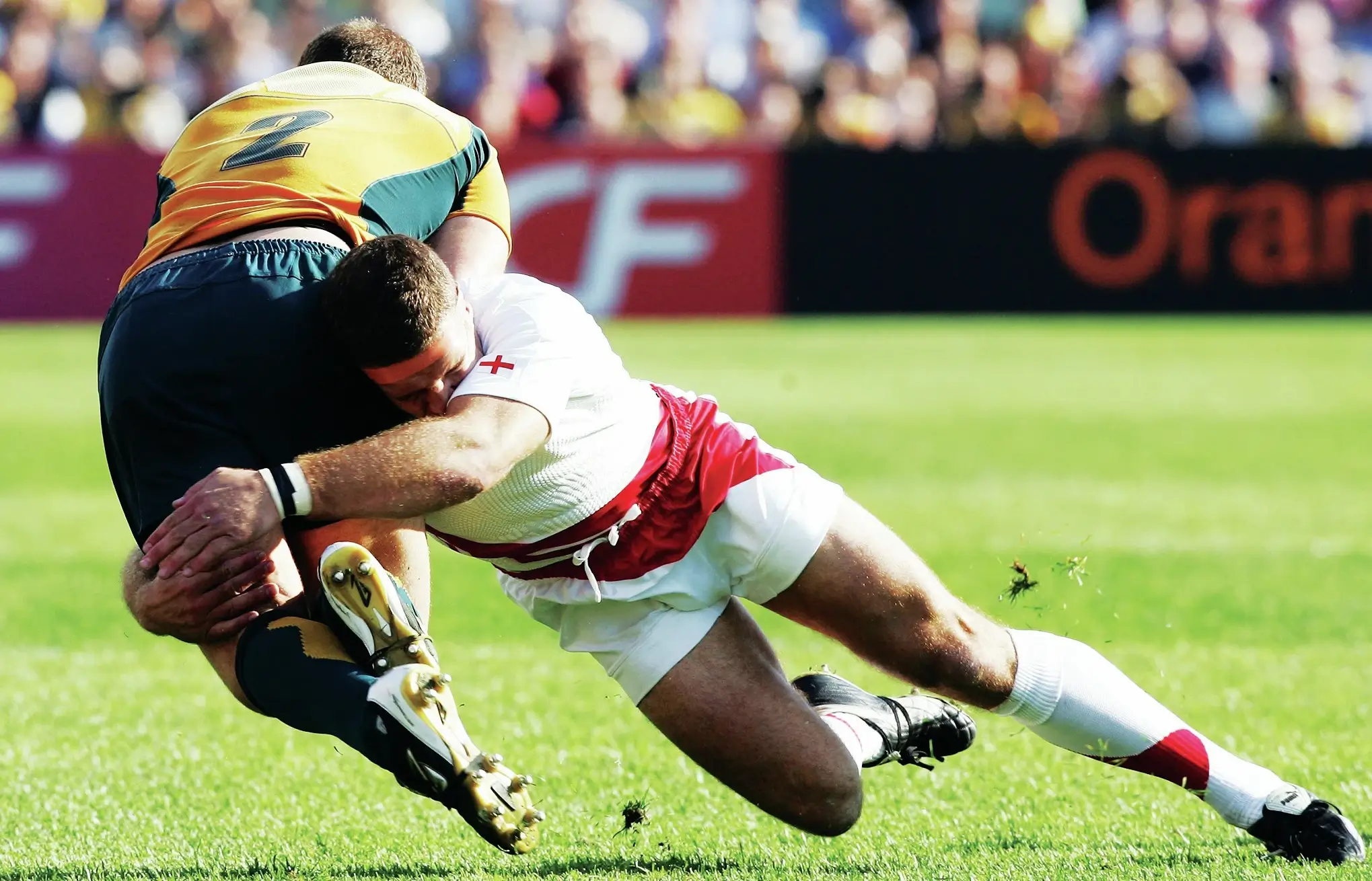 A rugby player tackling his opponent